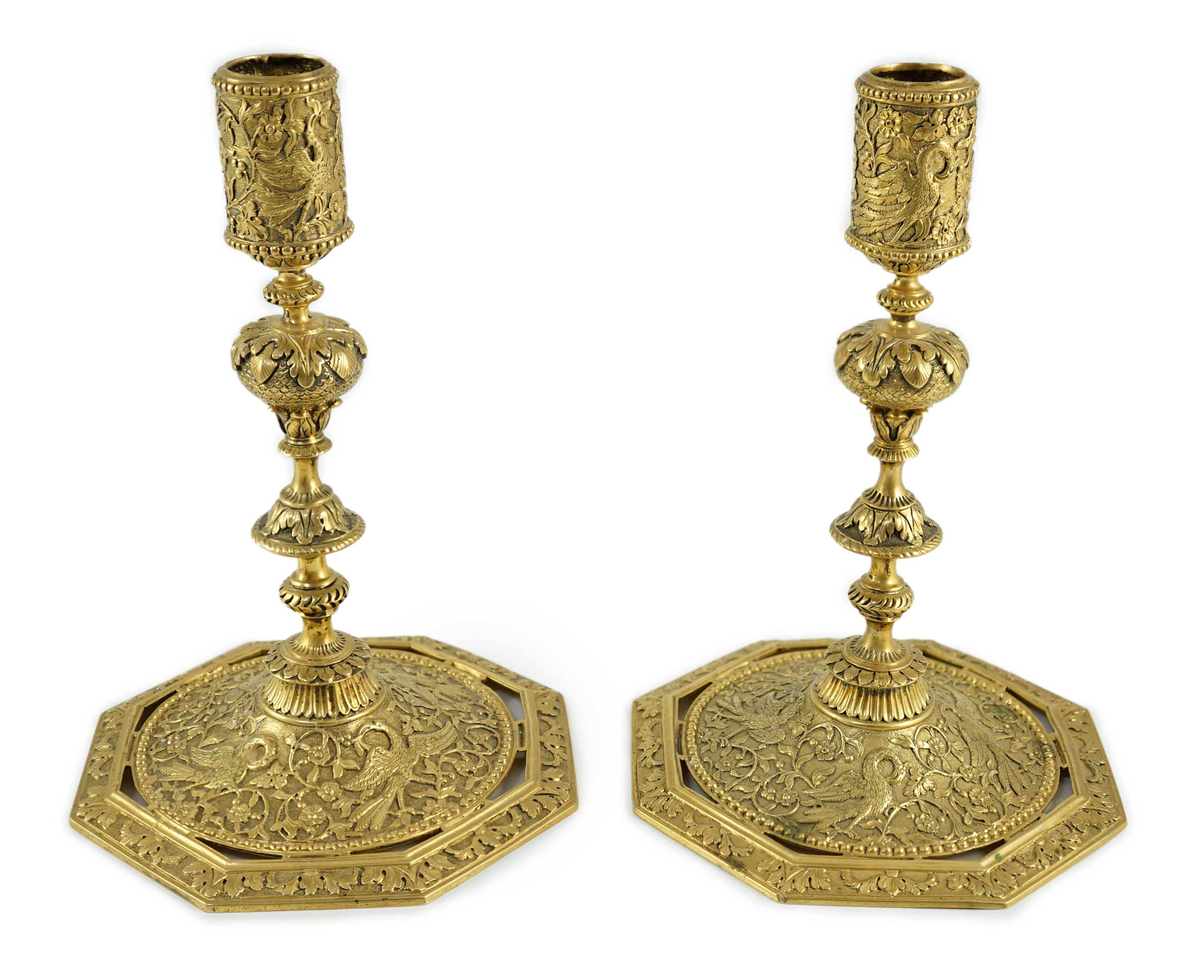 An ornate pair of Victorian silver gilt dwarf candlesticks, by John Wilmin Figg